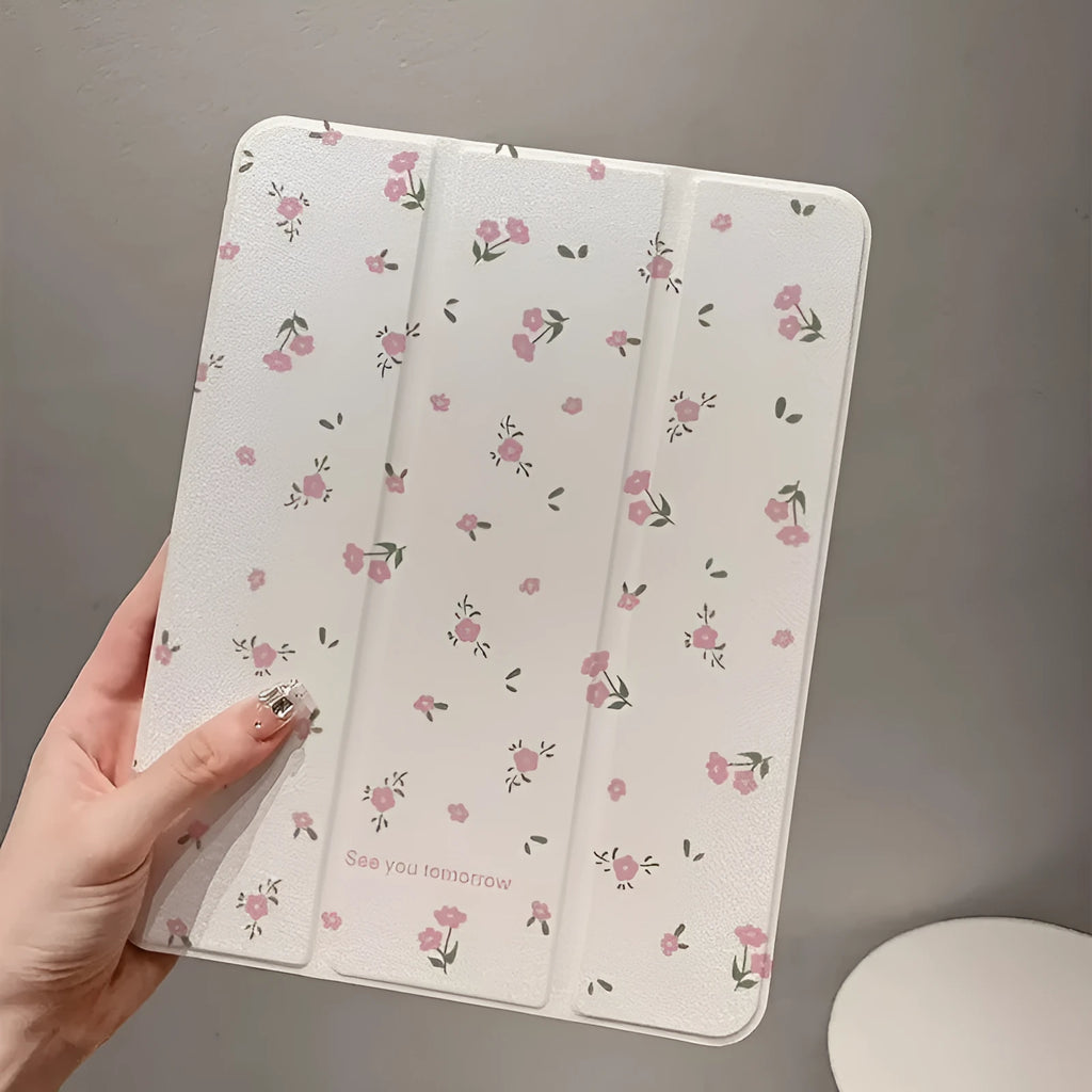 Clear iPad case with floral cartoon pattern, shown folded into a stand position.