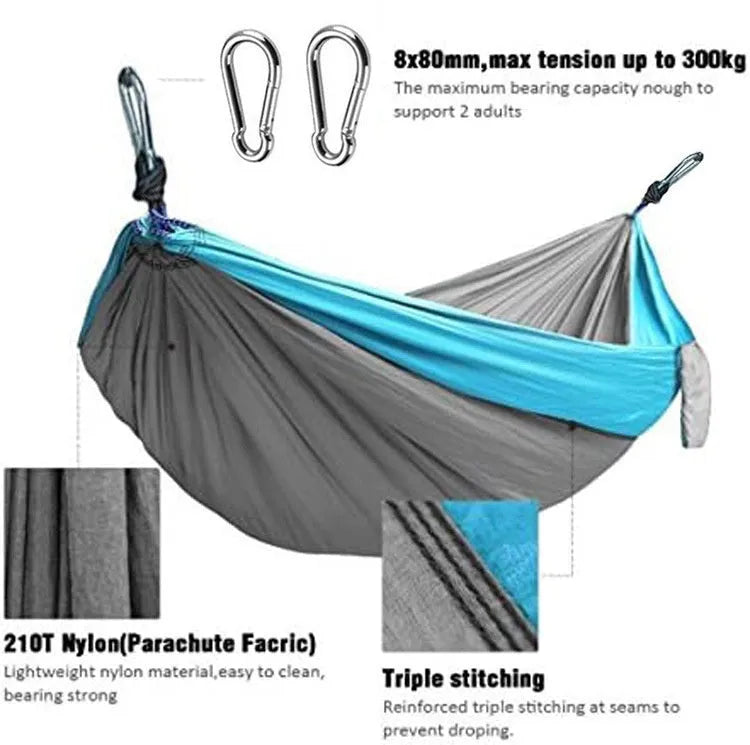Blue parachute nylon camping hammock hung between two trees, showing its full 270cm length.