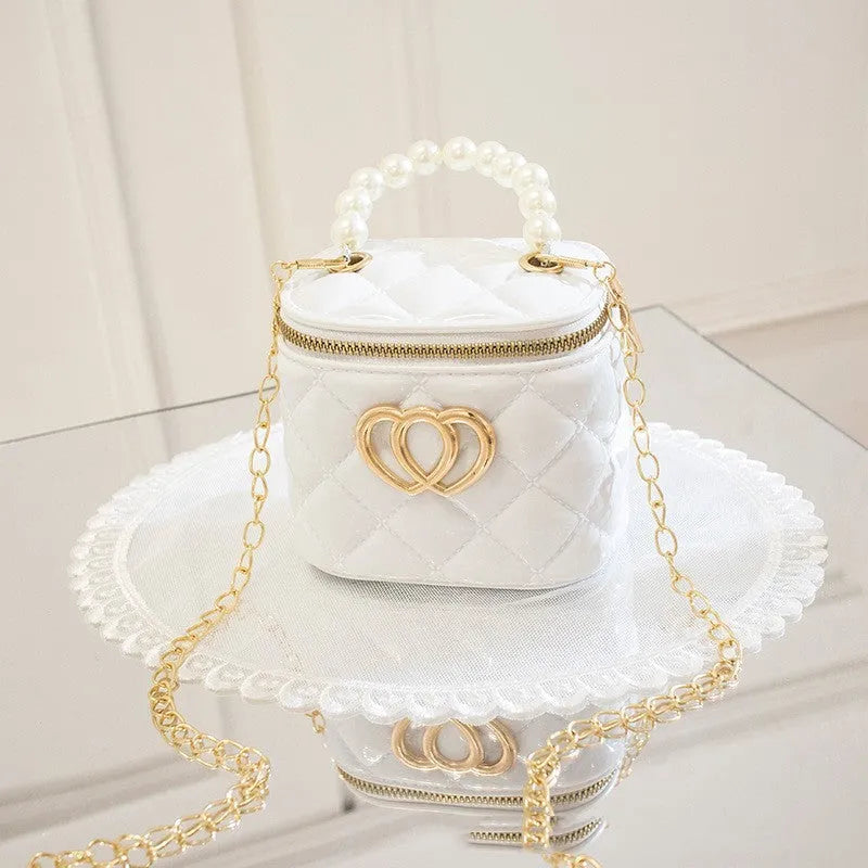 Women's white PVC bucket gel handbag with a red heart-shaped pattern lining.