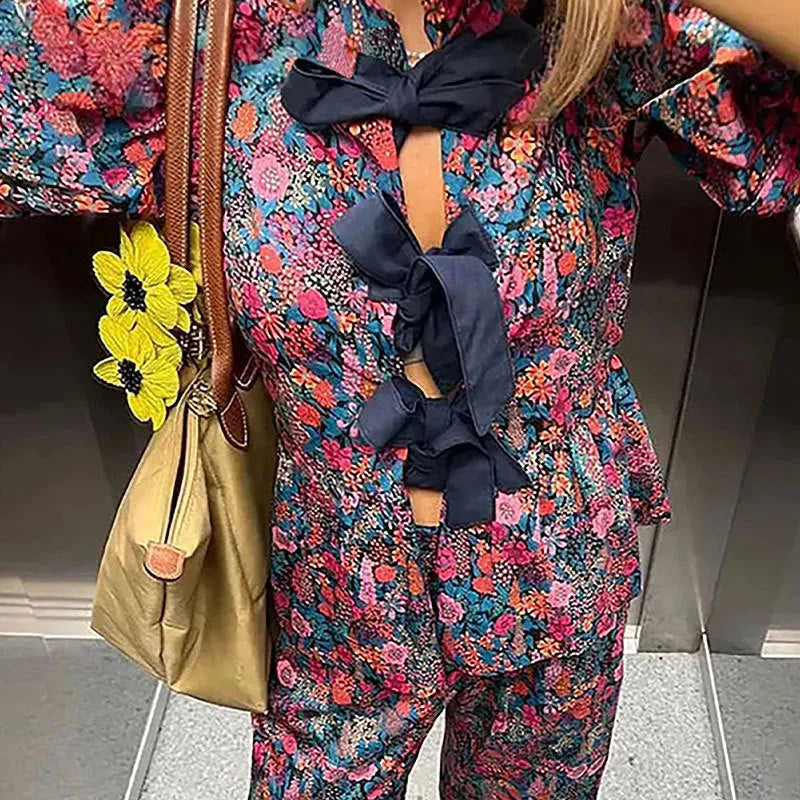 Women's floral print trouser suit set with tie-neck blouse and puff sleeves
