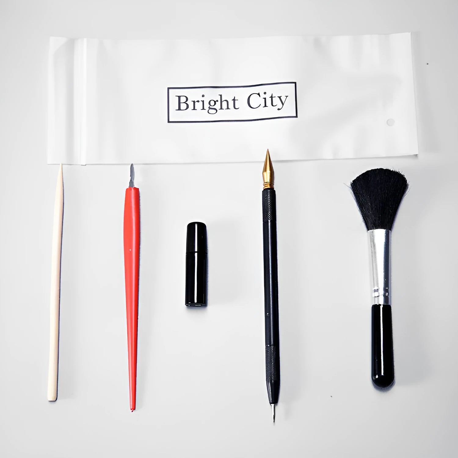 Scratch painting tool set with healing pens, brushes, scrapers, and photo frames on white card paper