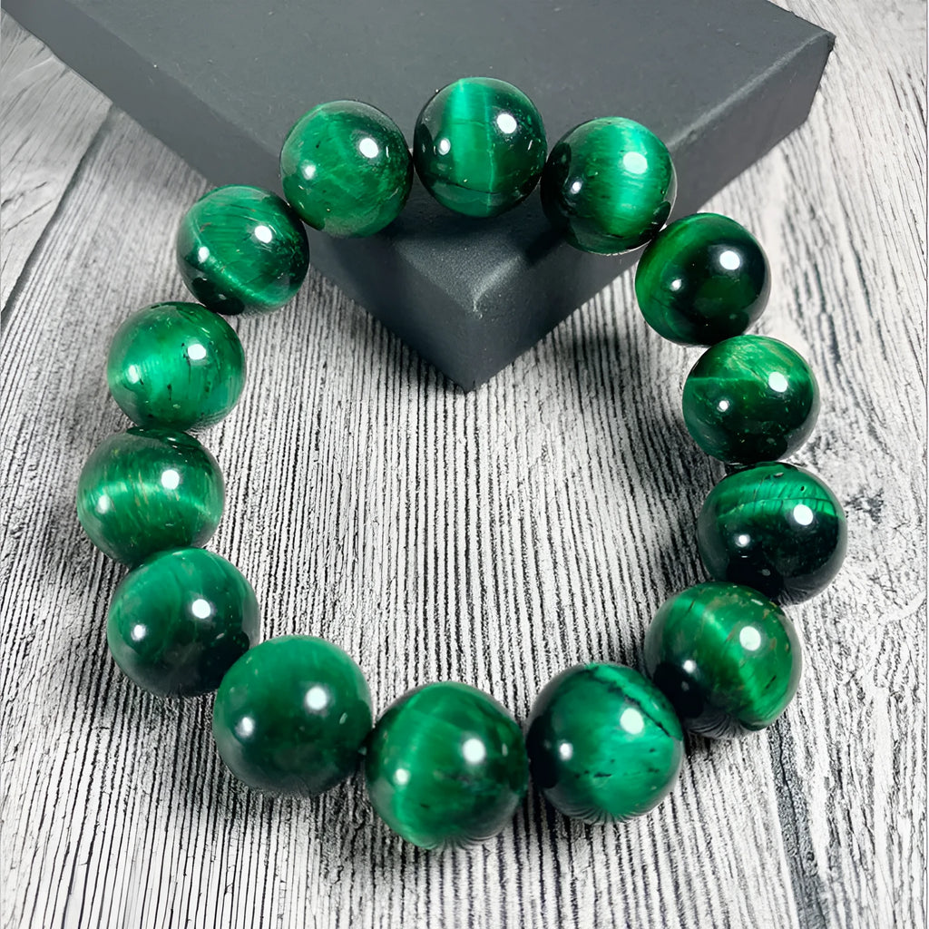 Green Natural Tiger Eye stone bracelet with geometric beads on a wrist.