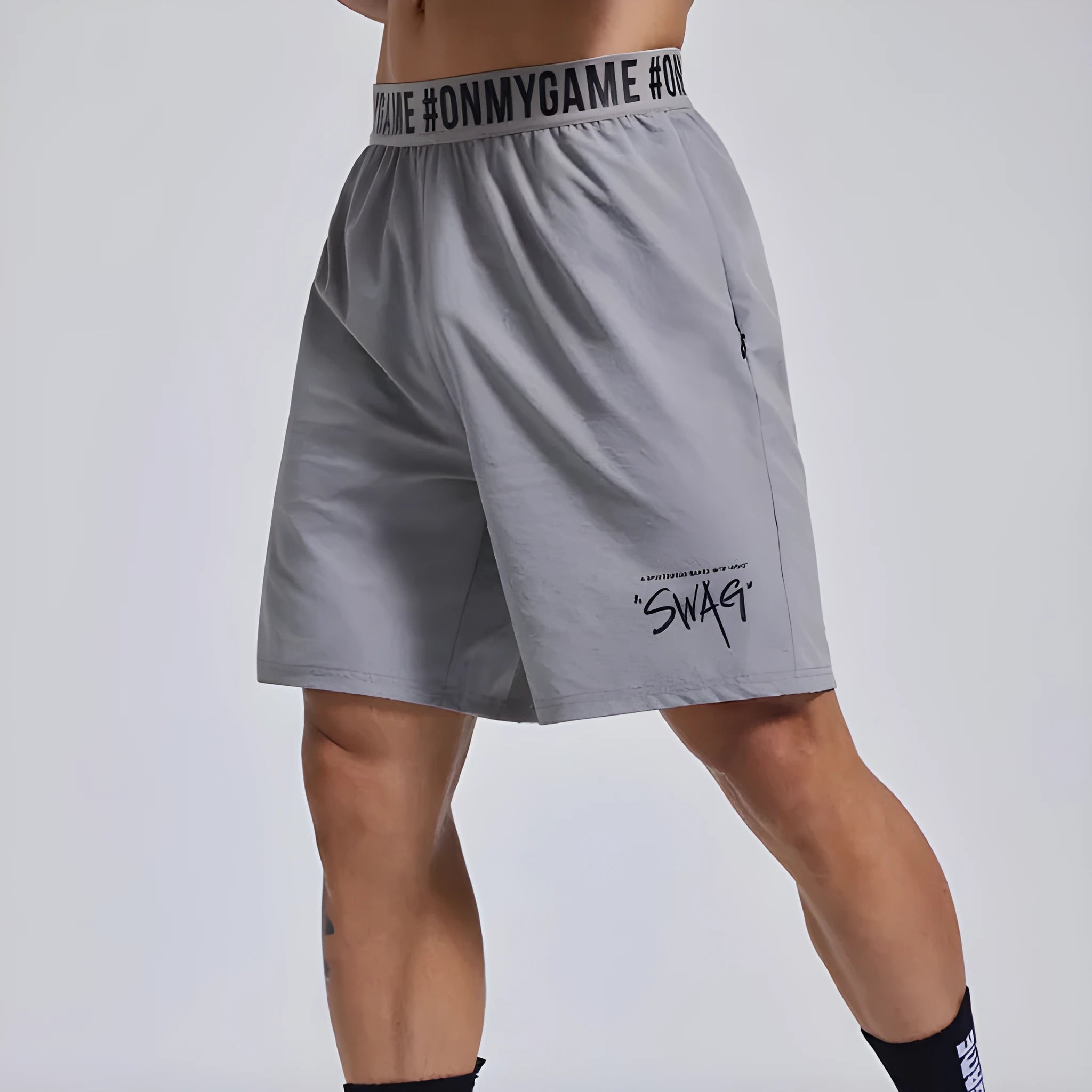Men's loose black sports shorts with elastic waist and letters detail, laid flat.