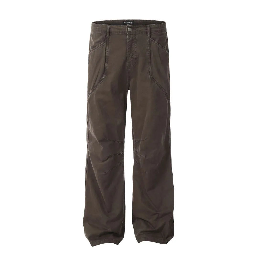 Men's loose straight-leg cotton trousers in brown, showing high waist and zipper fly.