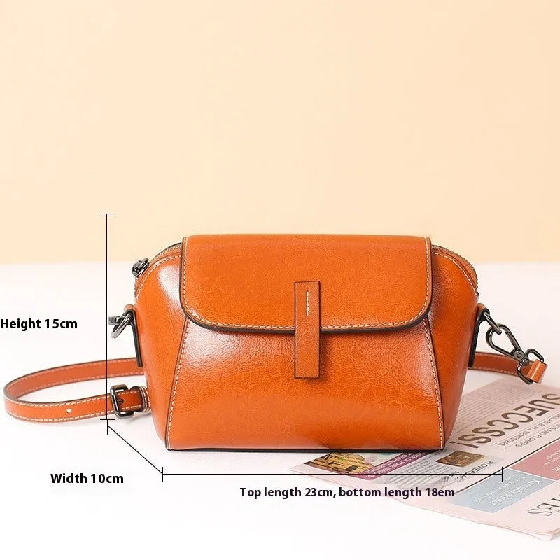 Women's brown oil wax leather messenger bag with crossbody strap and interior compartments
