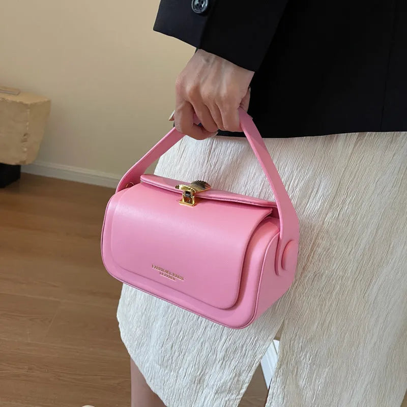 Women's personalised black PU leather shoulder messenger bag with letter detail and stitching.