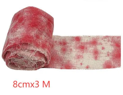 Roll of Halloween horror bandage in bloody red colour with a frayed end, showing its 8cm width and cloth-like polyester texture.