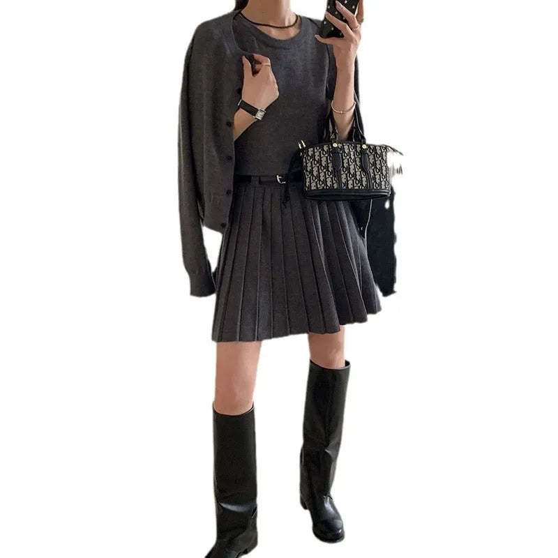 Grey art retro women's knitted cardigan and pleated vest skirt set with a waist belt.