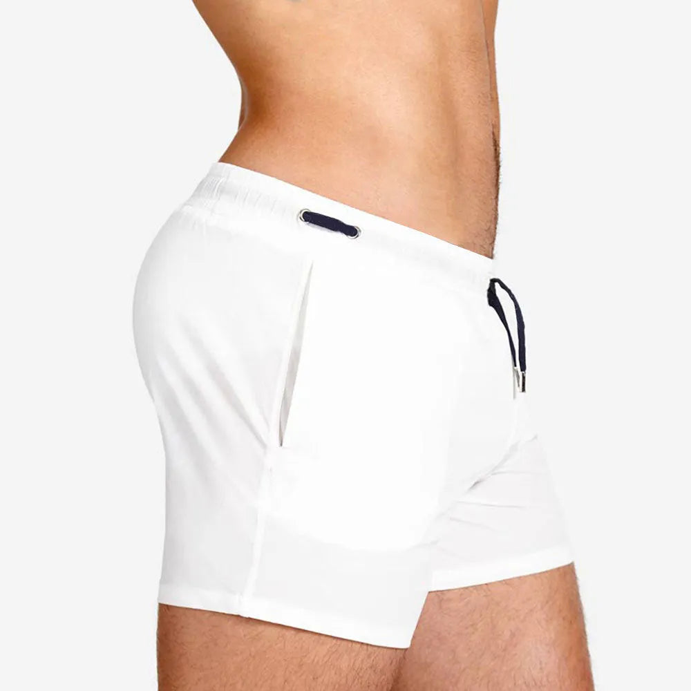 Solid colour polyester swimming and sports shorts with mesh lining in army green, on a white background.