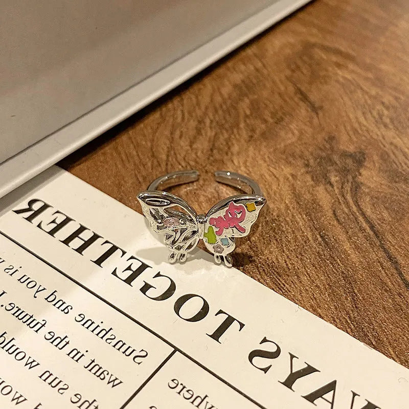 Copper butterfly women's ring with oil-drip finish showing open-loop design