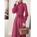 Rose red knit dress with a turtleneck collar, long sleeves, an elastic waist, and a loose big-hemmed midi skirt.