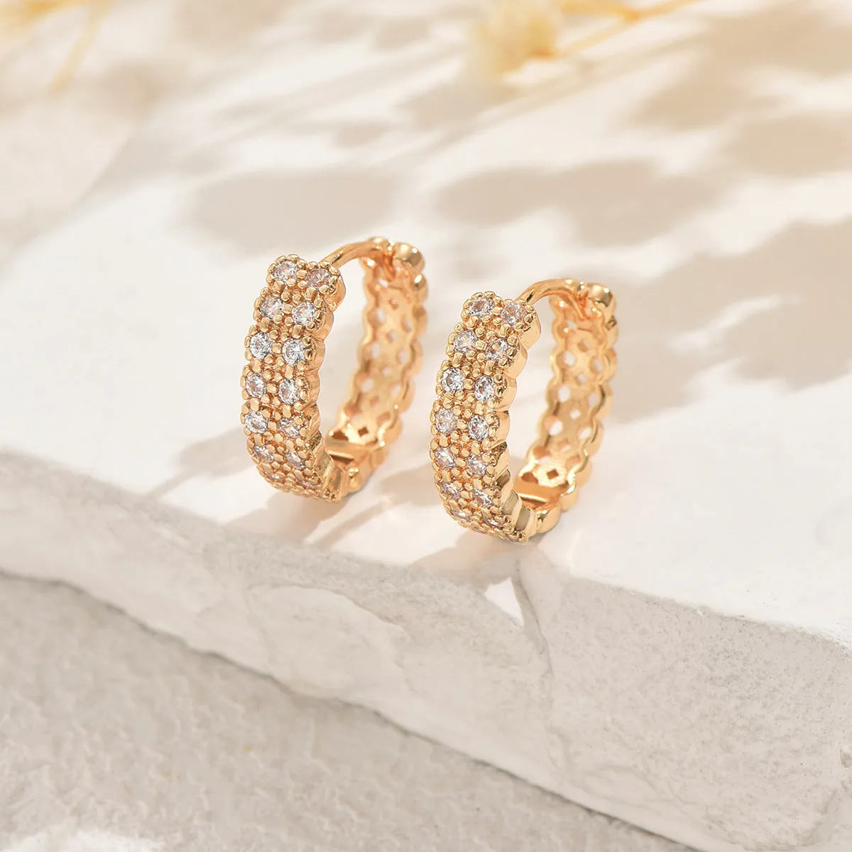 Geometric pattern copper ear studs with circular dot and ring decorative elements on ear