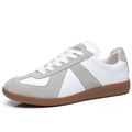 White Japanese-style retro low-top casual sneakers with round toe and flat rubber sole on a neutral background.