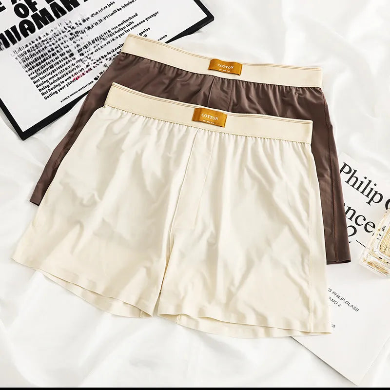 Men's solid colour loose ice silk underwear in a pack of three, shown in beige, black, and grey.