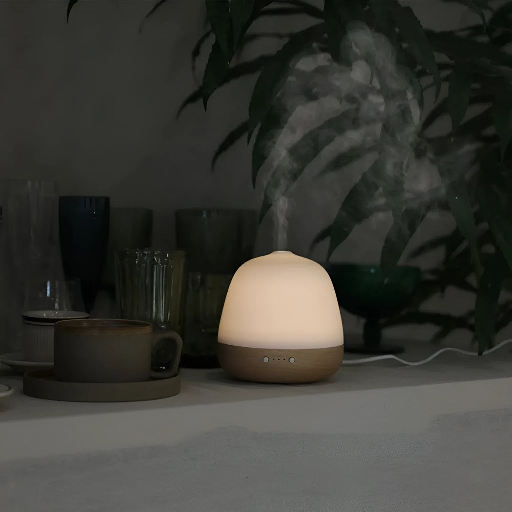 White ceramic ultrasonic essential oil humidifier with 180ml capacity on a table top