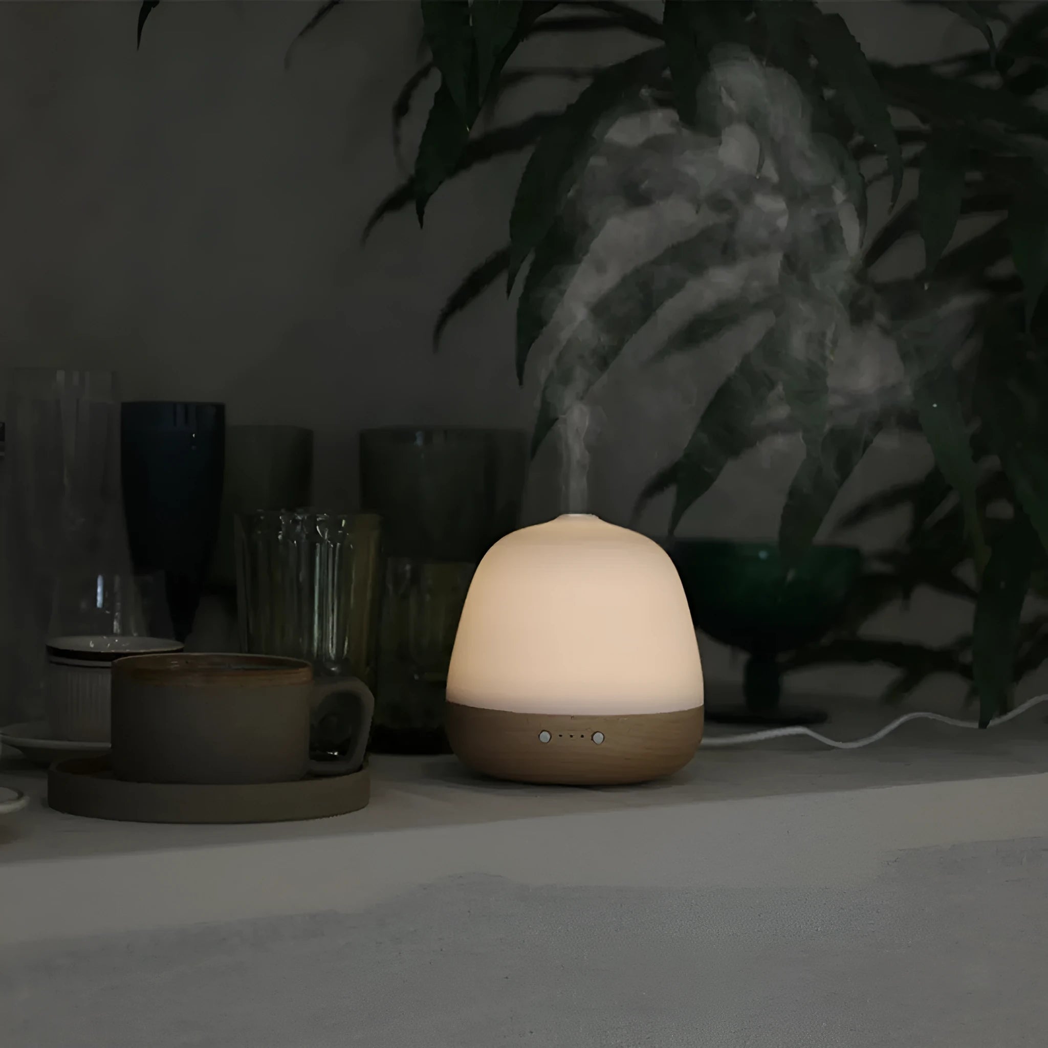 White ceramic ultrasonic essential oil humidifier with 180ml capacity on a table top