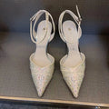 Women's silver high heel shoe with stiletto heel, pointed toe, and red sole on a white background.