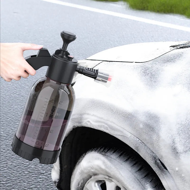 Black hand-held 2-litre multi-purpose sprayer with ergonomic handle and two nozzles