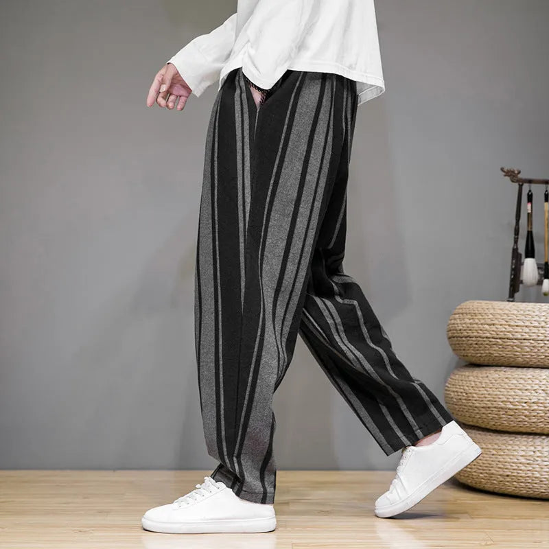 Men's navy blue and black striped wide-leg casual trousers with mid waist, laid flat.