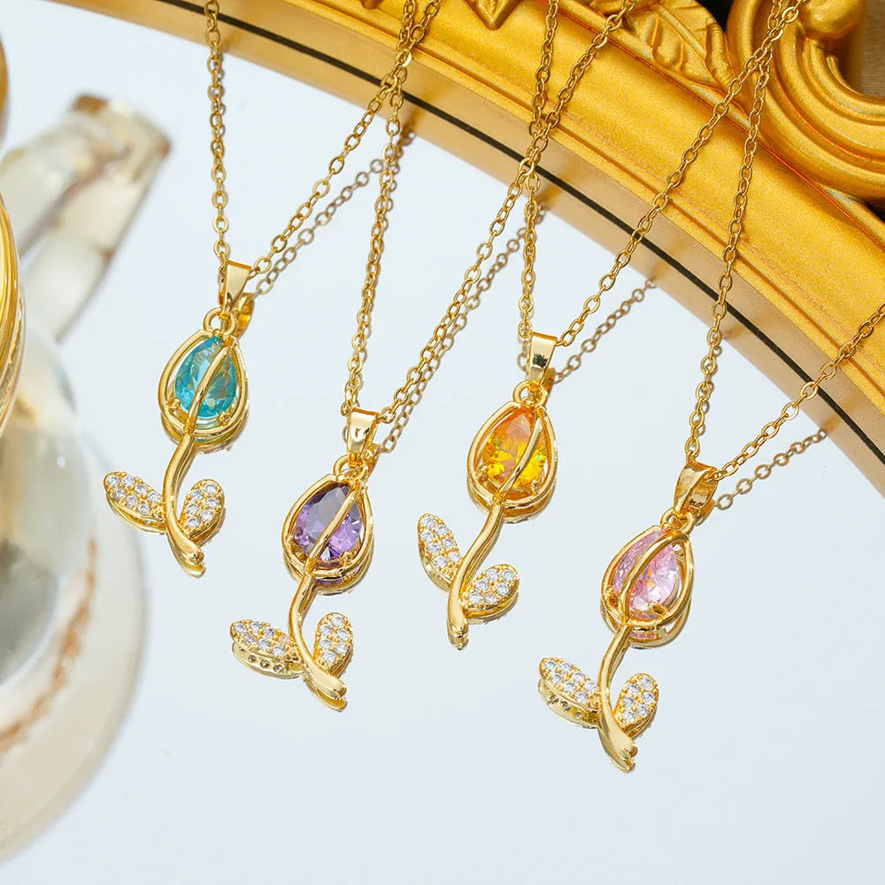 Gold-coloured zircon tulip pendant necklace on an adjustable O-ring chain, shown in pink, yellow, purple, green, and white colour variations.