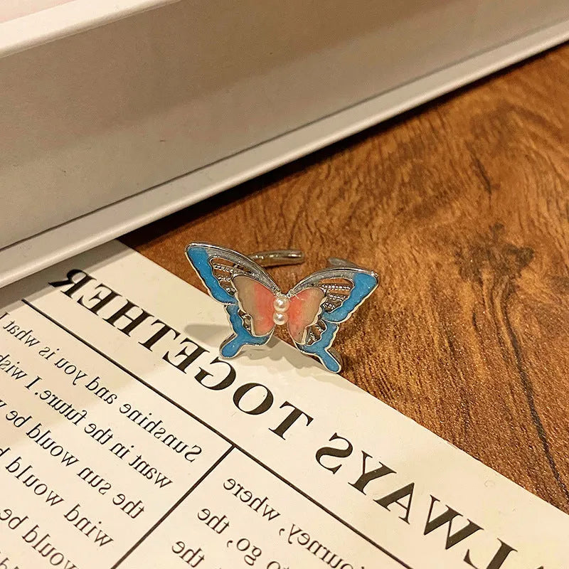 Copper butterfly women's ring with oil-drip finish showing open-loop design