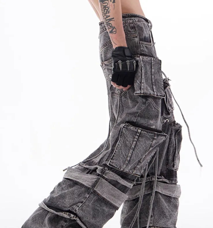 Grey distressed denim overalls with rope stitching detail on front