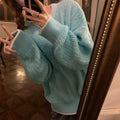 Women's lake blue loose retro pullover sweater on a hanger, showing its regular sleeves and solid colour.