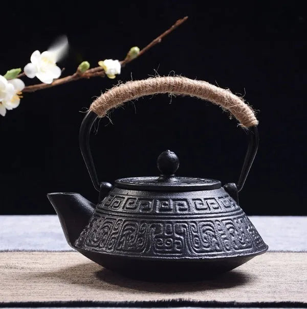 Japanese cast iron teapot in black with Peony pattern, showing lid, handle, and spout.