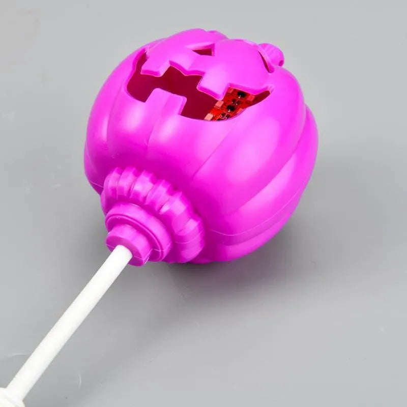 Plastic pumpkin-shaped USB lamp emitting yellow or purple light, 8.3cm wide by 22cm tall