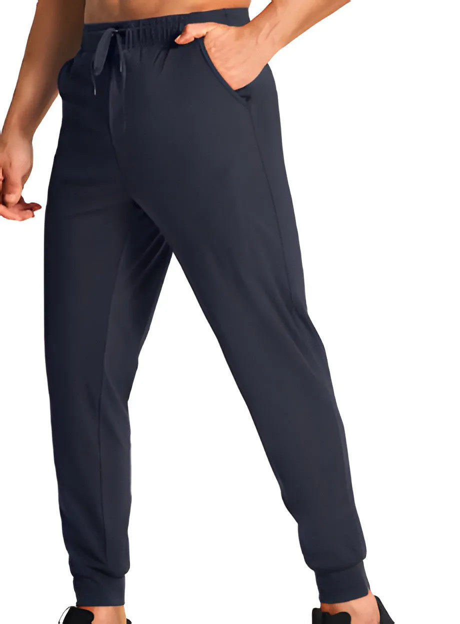 Men's solid colour loose casual trousers in polyester fabric on a hanger.