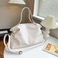 Large horizontal soft PU messenger bag in black with zip opening and long shoulder strap.