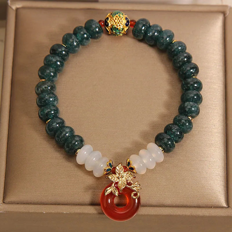 Blue water jade and red agate bracelet with peace buckle charm and rhinestone details