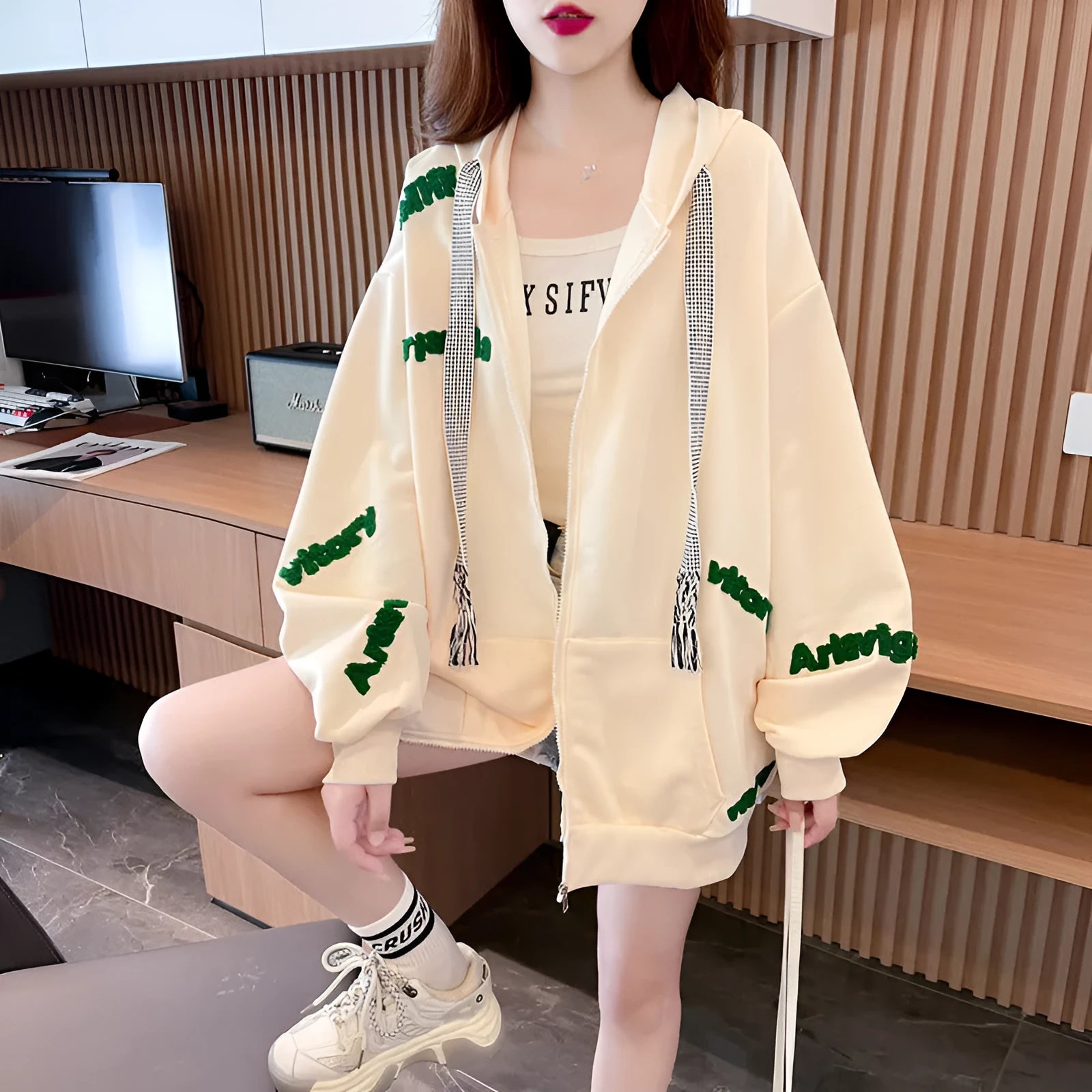 Loose large letter hooded cardigan coat for women in apricot with black lettering, long sleeves, and relaxed fit