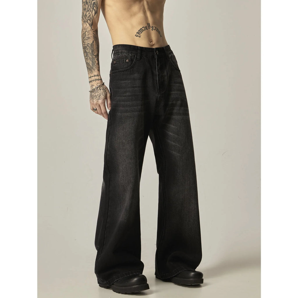 Black loose straight-leg retro jeans on a mannequin, showing zipper fly and relaxed fit.