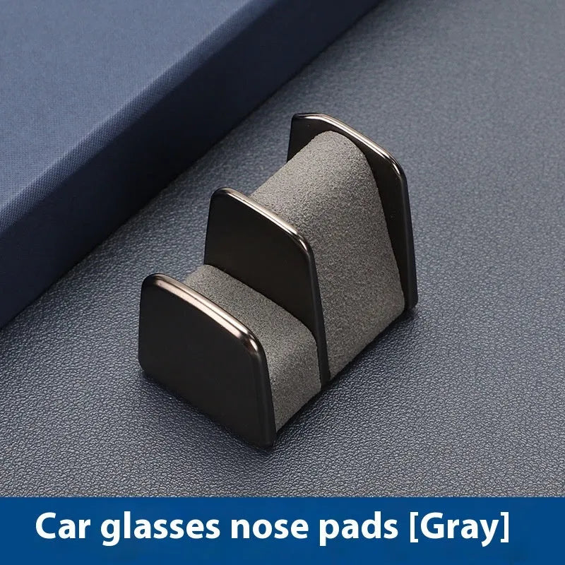 Zinc alloy and leather car dashboard clip for holding glasses in black, grey, green, or red.