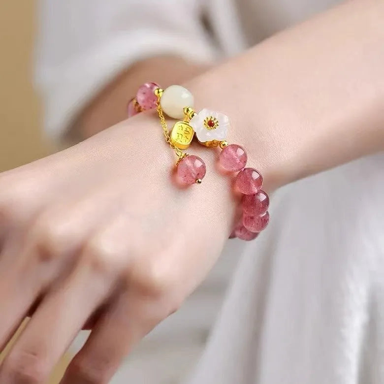 Hetian jade and strawberry quartz crystal bracelet for women showing manual craftsmanship and natural stone variations