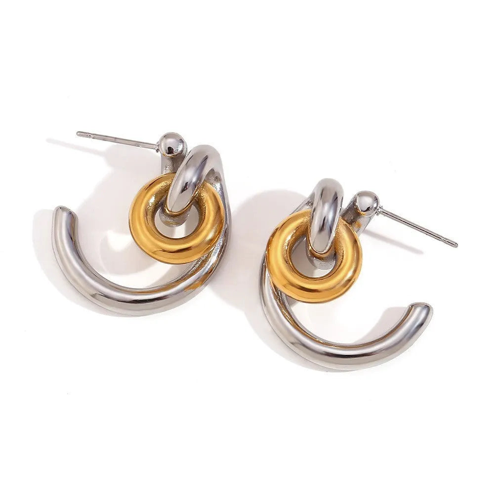 Gold geometric stainless steel earrings, bracelet, and necklace set on a white background.