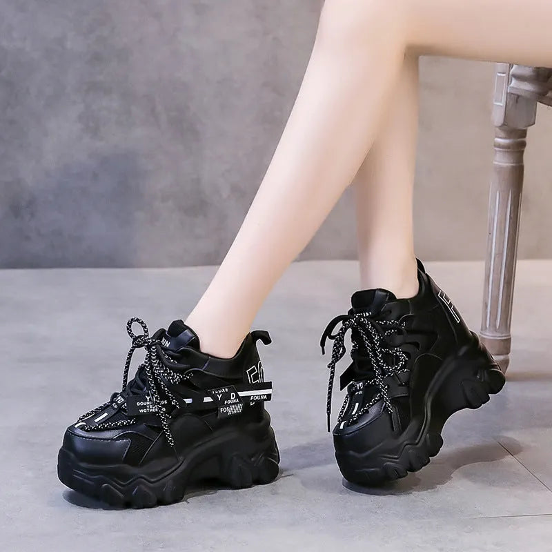 Women's white mesh platform sports shoes with cross strap and a high rubber sole.