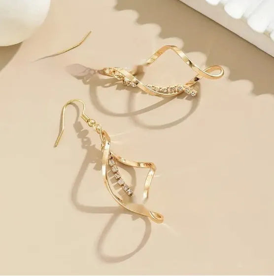 Gold colour geometric spiral design alloy earrings with elliptical elements for female wearers