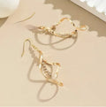 Gold colour geometric spiral design alloy earrings with elliptical elements for female wearers