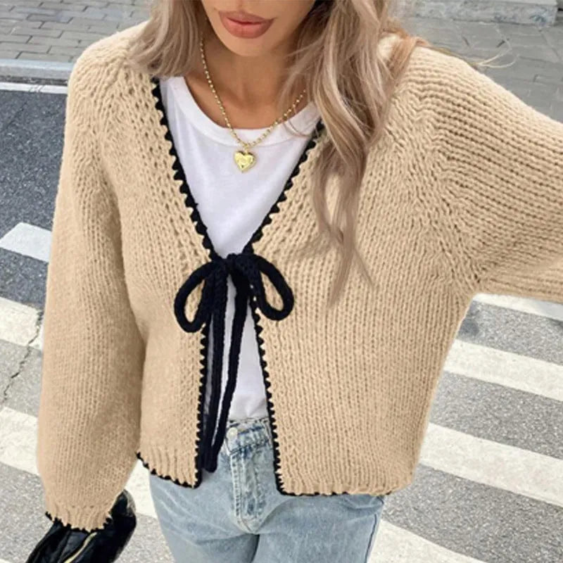 Gray lace-up front cardigan sweater with white crochet flower details and loose long sleeves.
