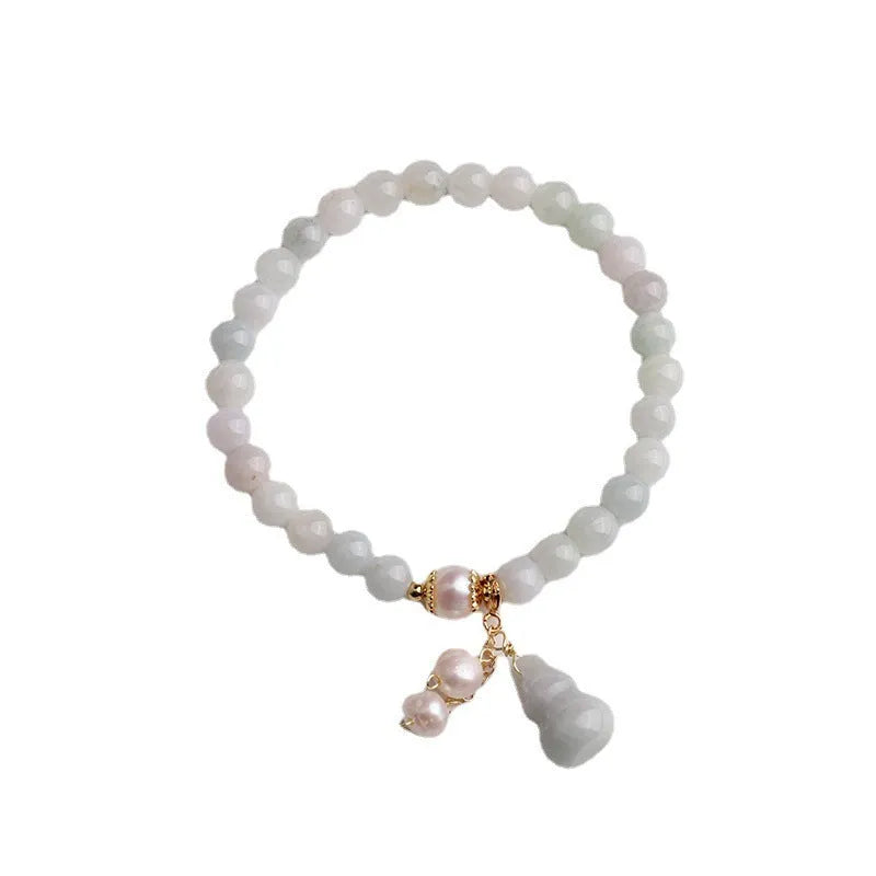 Chinese style jade bracelet with gourd design and pearl accents in natural emerald colour
