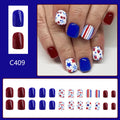 Short glossy false nails with strawberry and cherry pattern on red and blue background.
