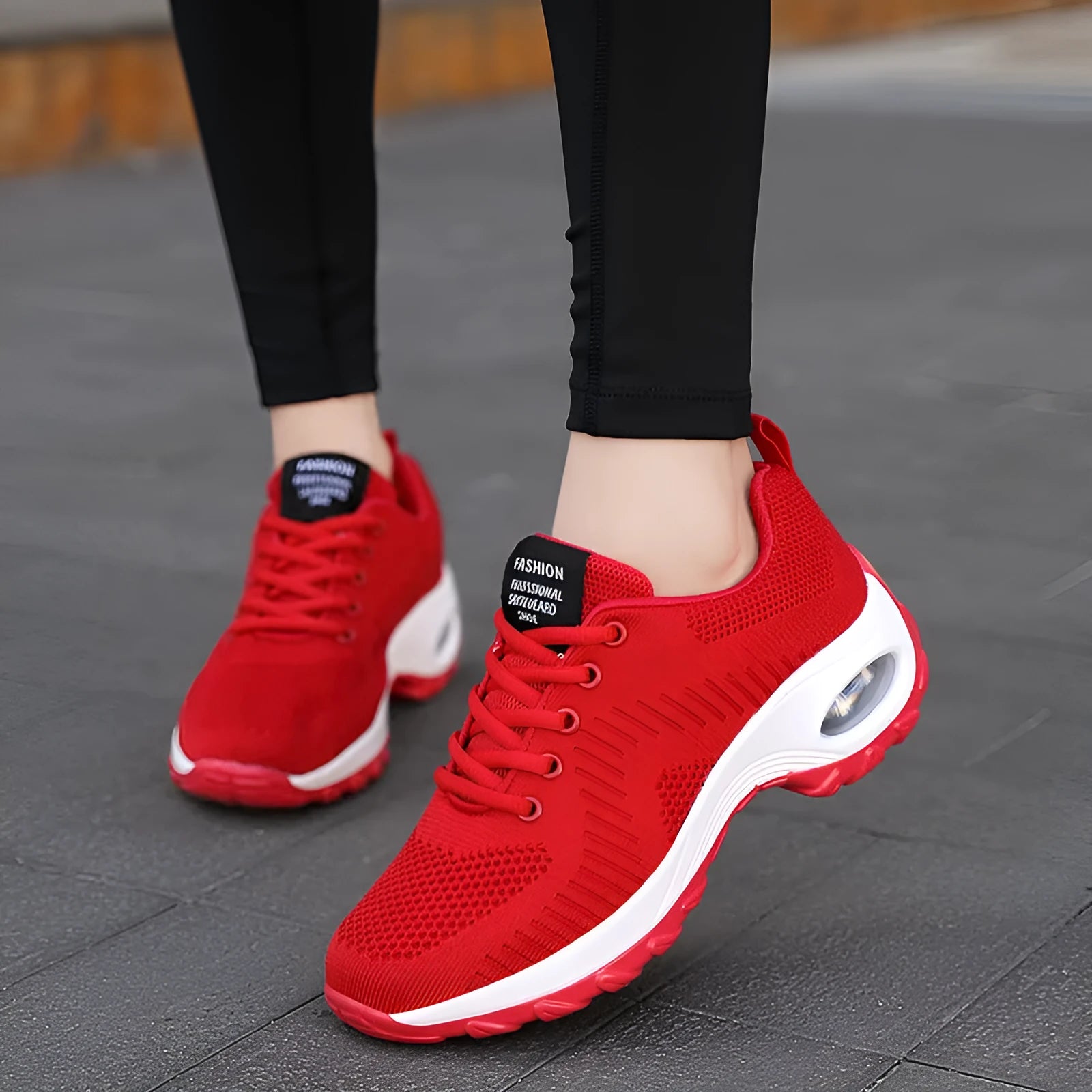 Red and black women's low top lace-up mesh sneakers with a round toe and flat PU sole.