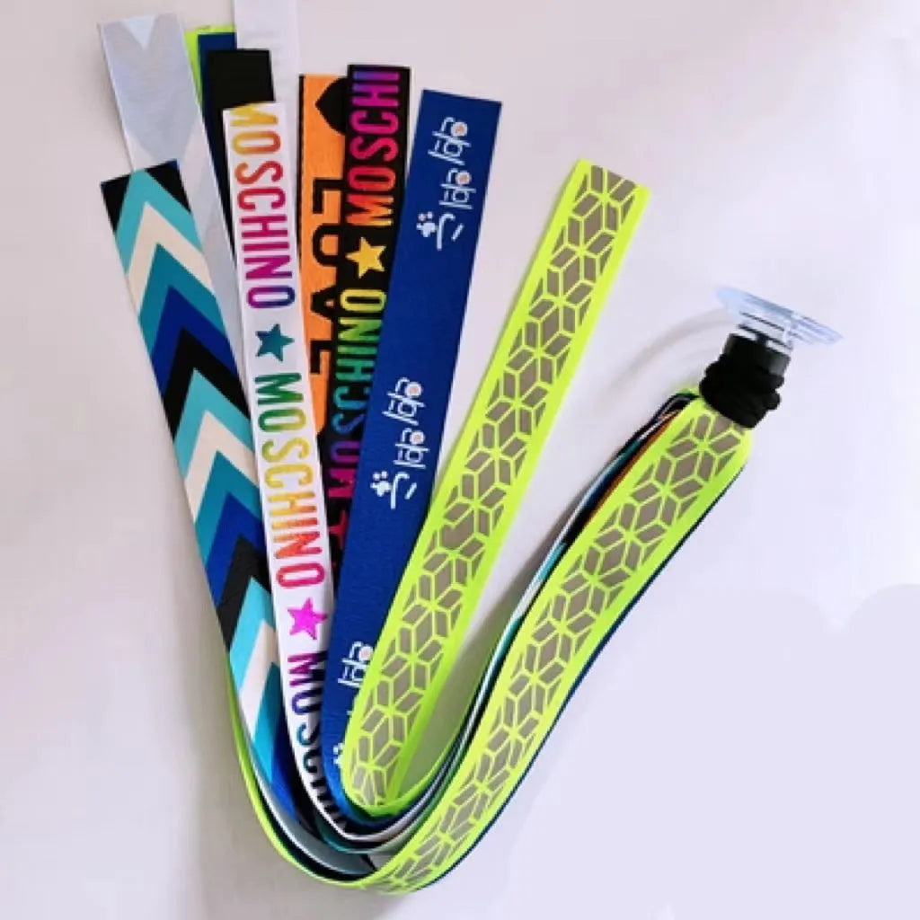 Colourful fabric helmet streamers for children's roller skating and ski helmets, shown in apricot, red, and grey.