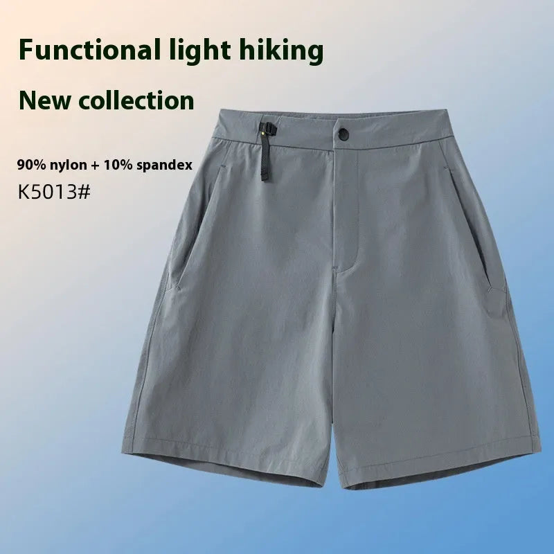 Men's solid colour quick-dry sports shorts with elastic sides on a neutral background.