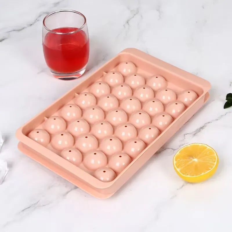 Blue silicone ice cube tray with lid showing 33 round cavities for large ice.
