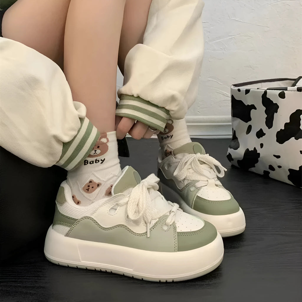 Green women's casual shoes with mesh upper, flat heels, and round toe design