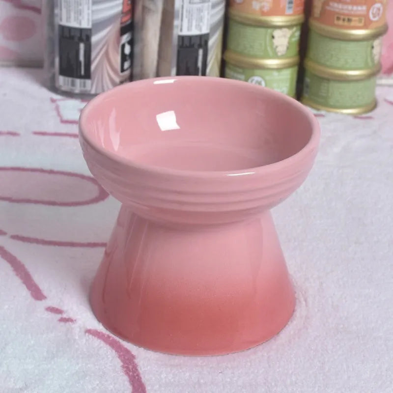 Black chin-high foot ceramic pet bowl for dogs and cats on a flat surface.