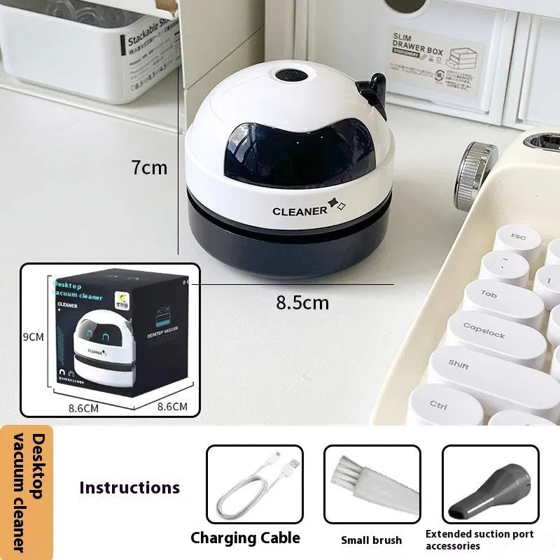 Handheld USB rechargeable desktop vacuum cleaner in a choice of rocket or animal designs on a desk.